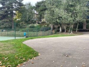3. On the wider tarmac area by the tennis courts where paths meet